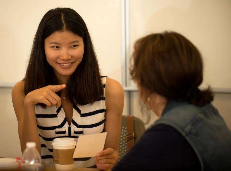 Female student talks to another student