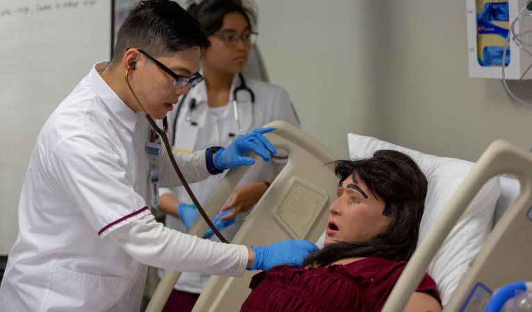 Nursing student works on simulator