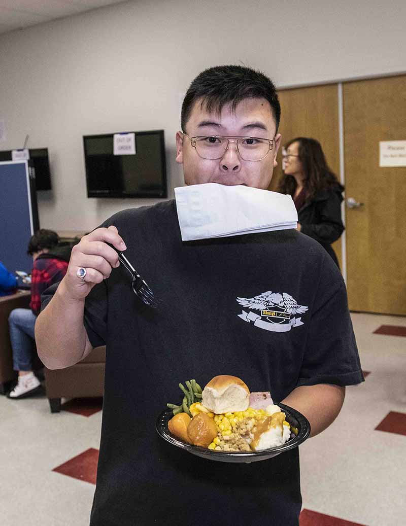 Student enjoys Thanksgiving Dinner