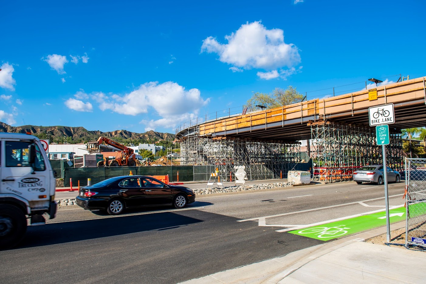 Cars heading east pass under new bridge