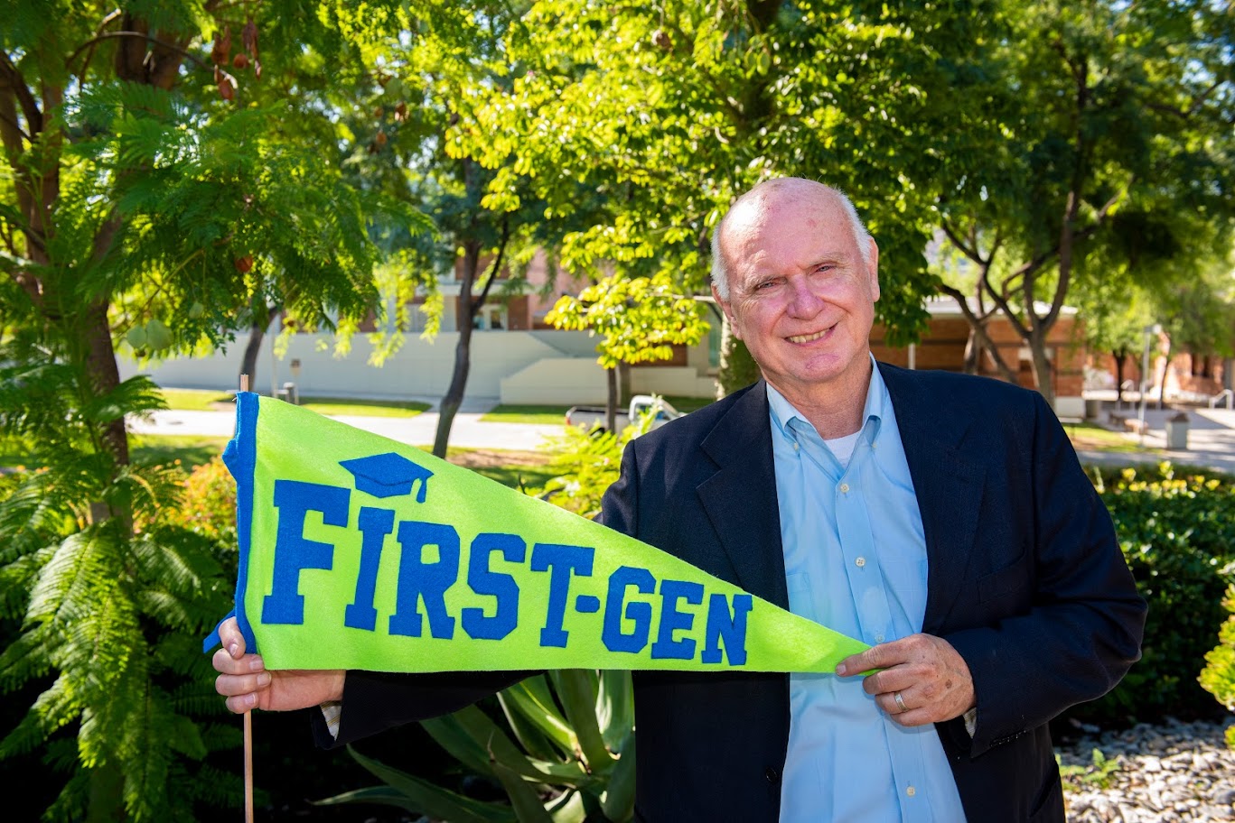 Bill Scroggins holding first gen pennant