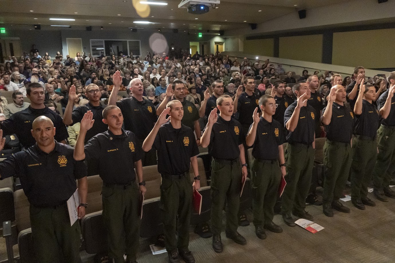 group of male students raising their hand to take an oath