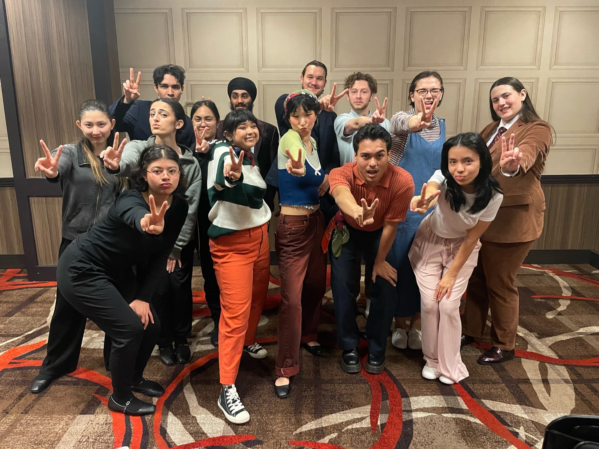 Group of students giving the peace sign