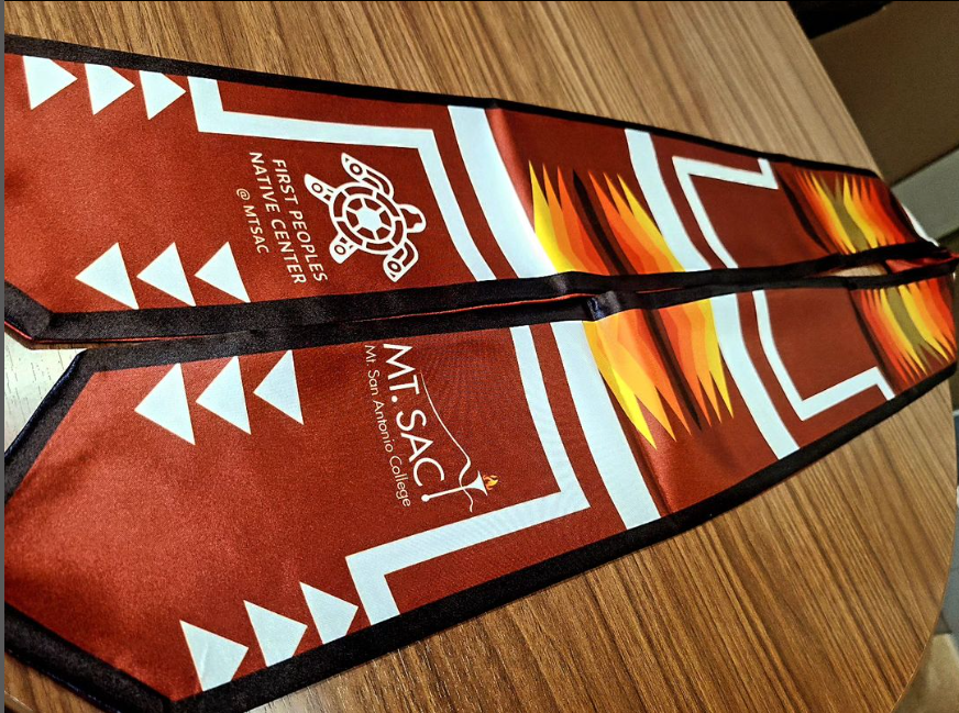Red satin sash with First Peoples Native Center logo