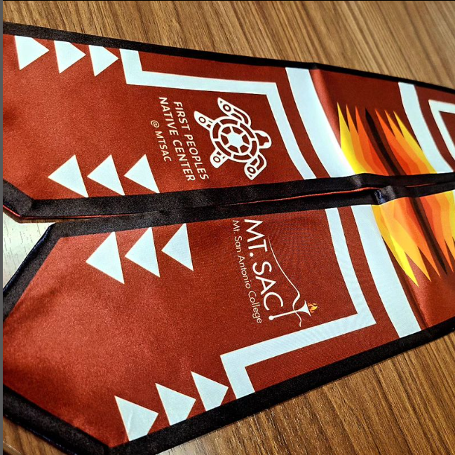 Native Graduation sashes of red and yellow lay on table