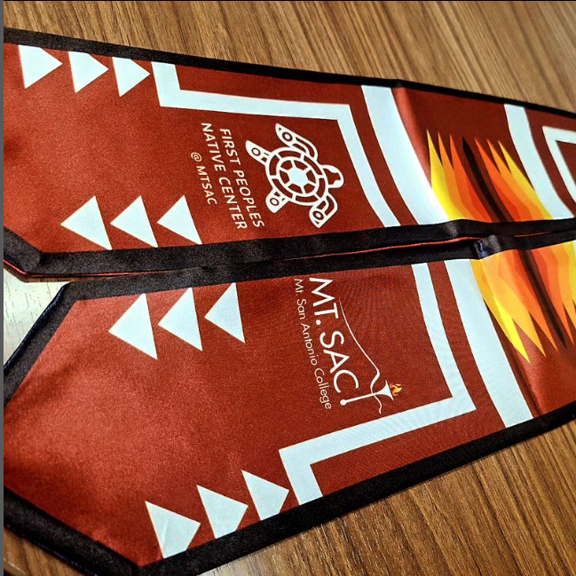 Red satin sash with First Peoples Native Center logo