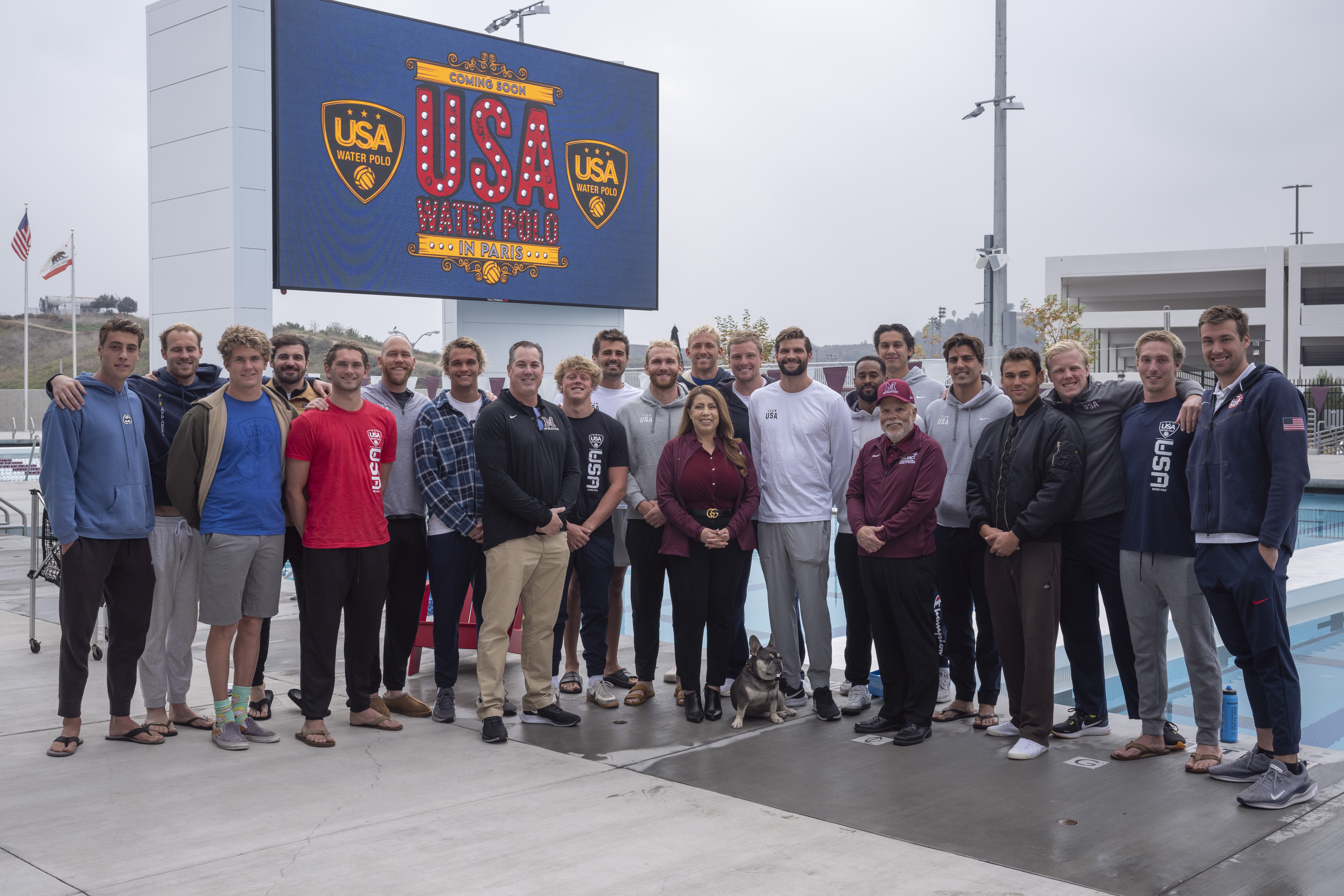 USA Water Polo players gather along pool for group photo with Dr Garcia and Dr Baca