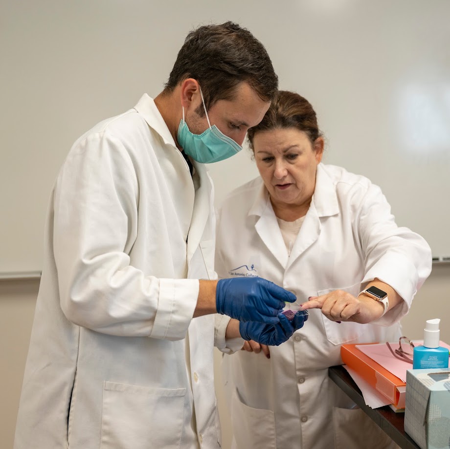 Professor and student look at a glass slide
