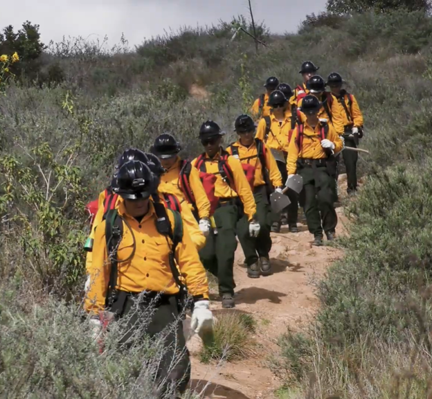 A group of firefighter cadets walk down a hill
