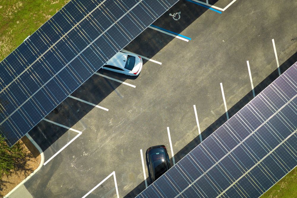 Cars parked under canopy-mounted solar panel structures