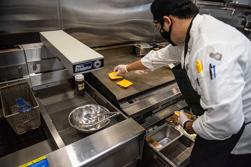 Adding cheese to the burger