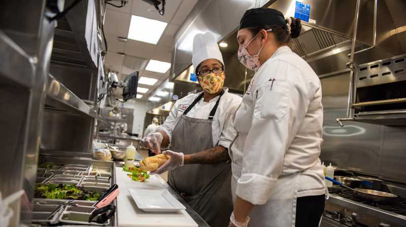 Lab Tech Margaret Speak demonstrates to a student 