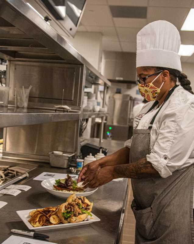 A lab technician inspects a dish