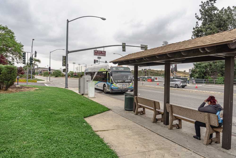 Bus rider waits for Foothill Transit bus at soon-to-close stop