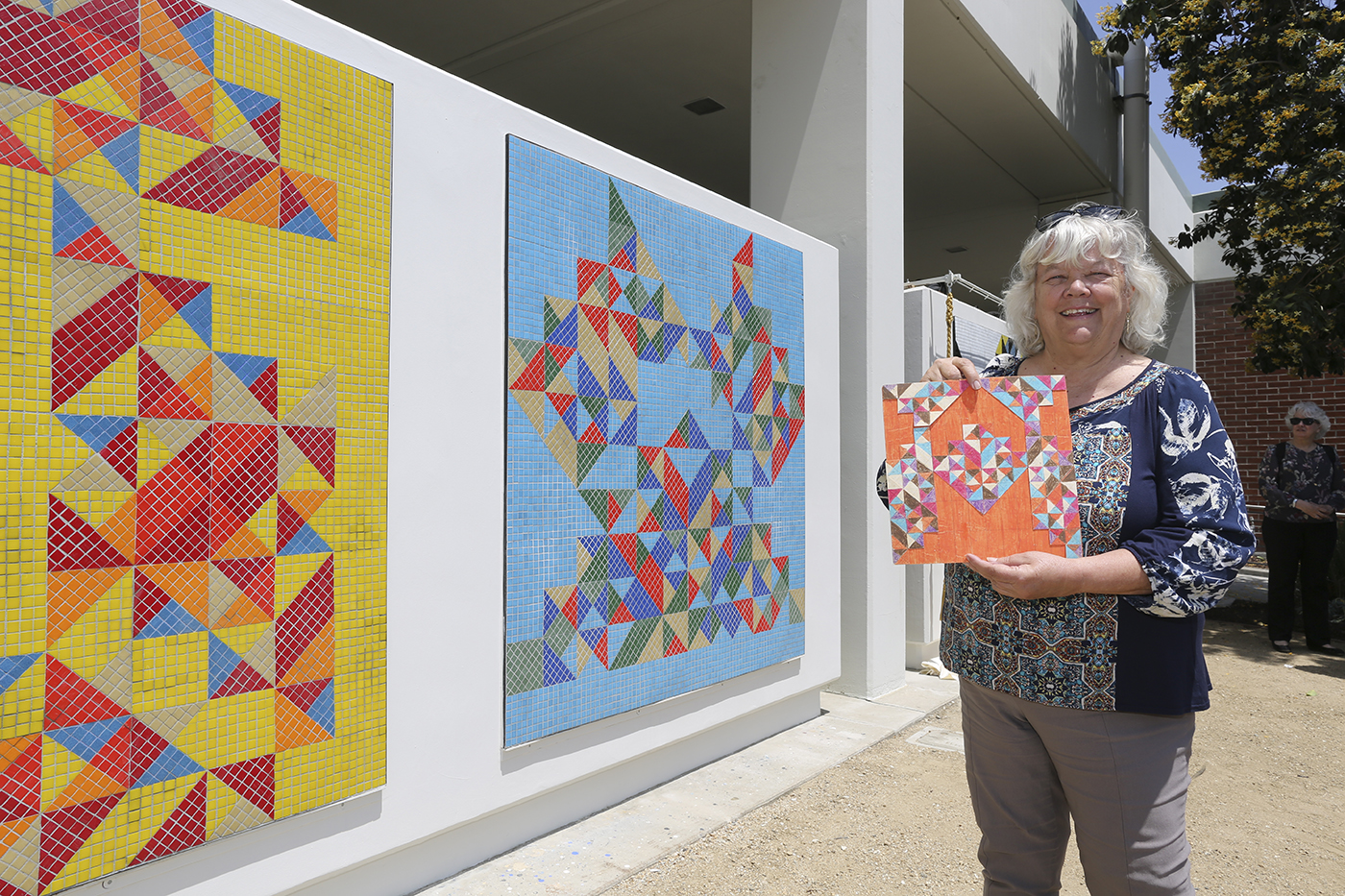 Woman standing in front of artwork at the 2019 Culturama event.