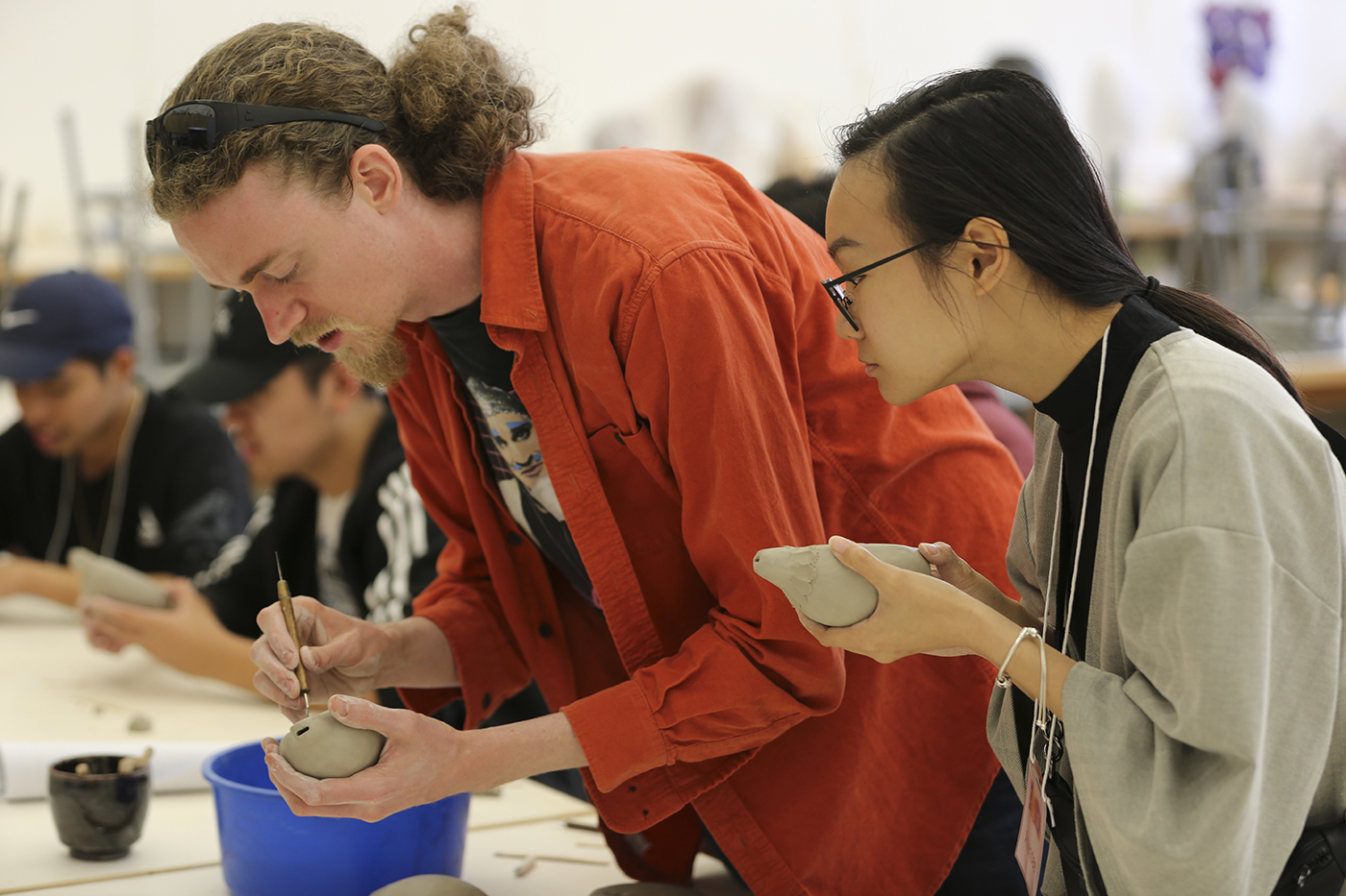 Students molding clay.