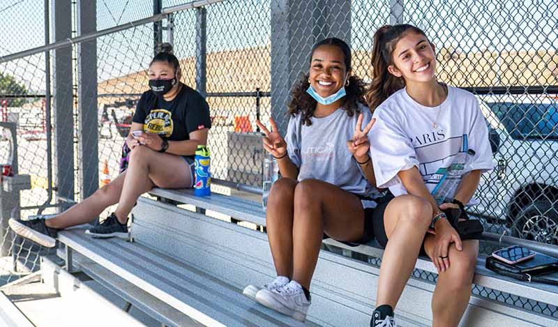 Students in bleachers of the tennis courts 