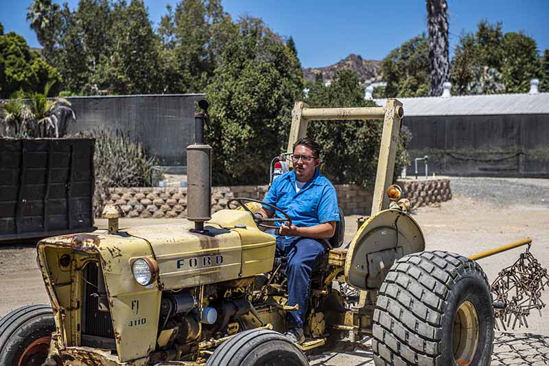 Student operates tractor