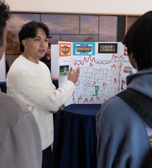 An Arise student taking C1000 shares their museum exhibit about their culture with visitors. 