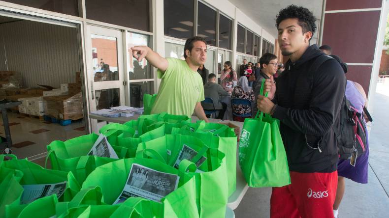 Employee helps a student with Cal Fresh