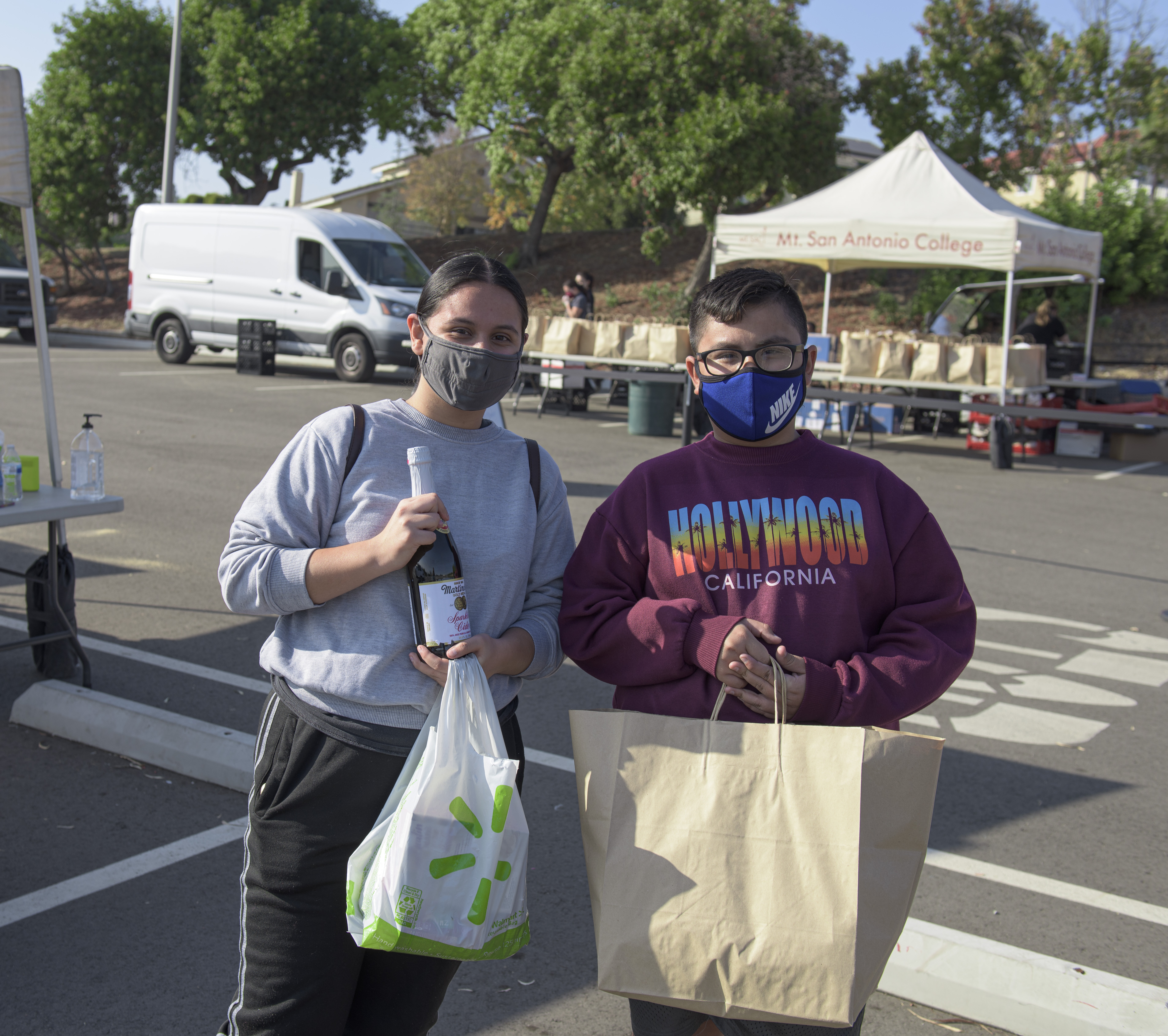 students with bags of meals and groceries