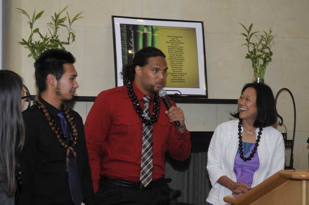 Audrey (R) at podium with students