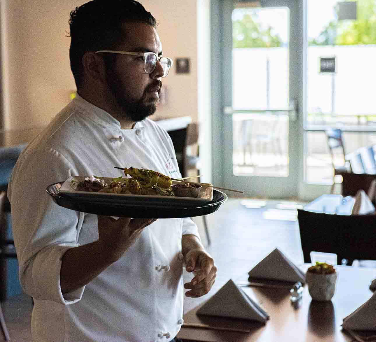 Adrian serving a meal