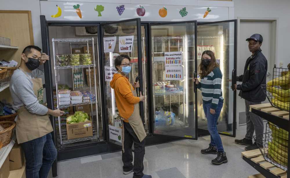 Student workers hold open the doors to the coolers