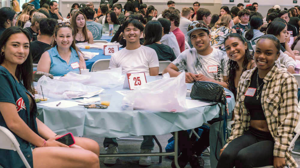 Students  smile at table