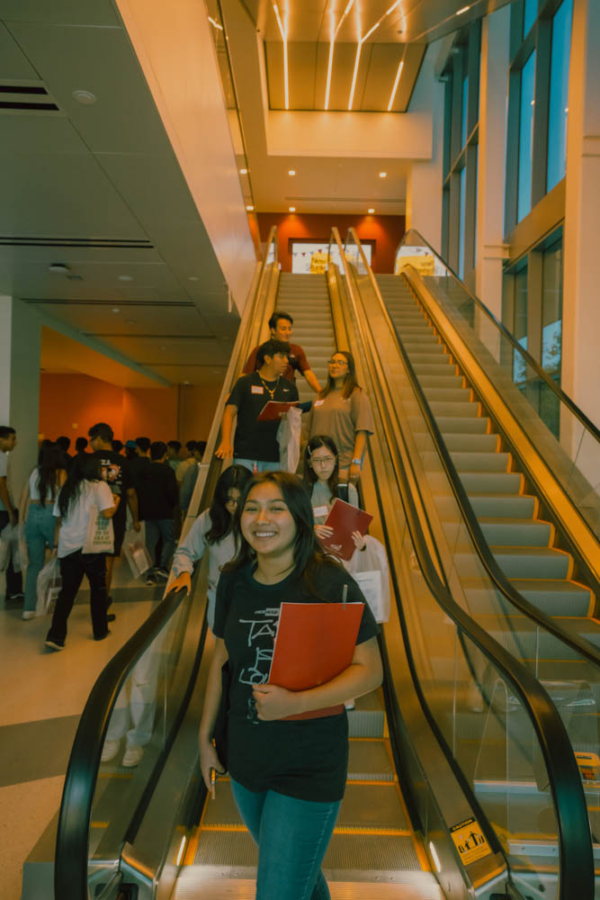 Students come down the escalator