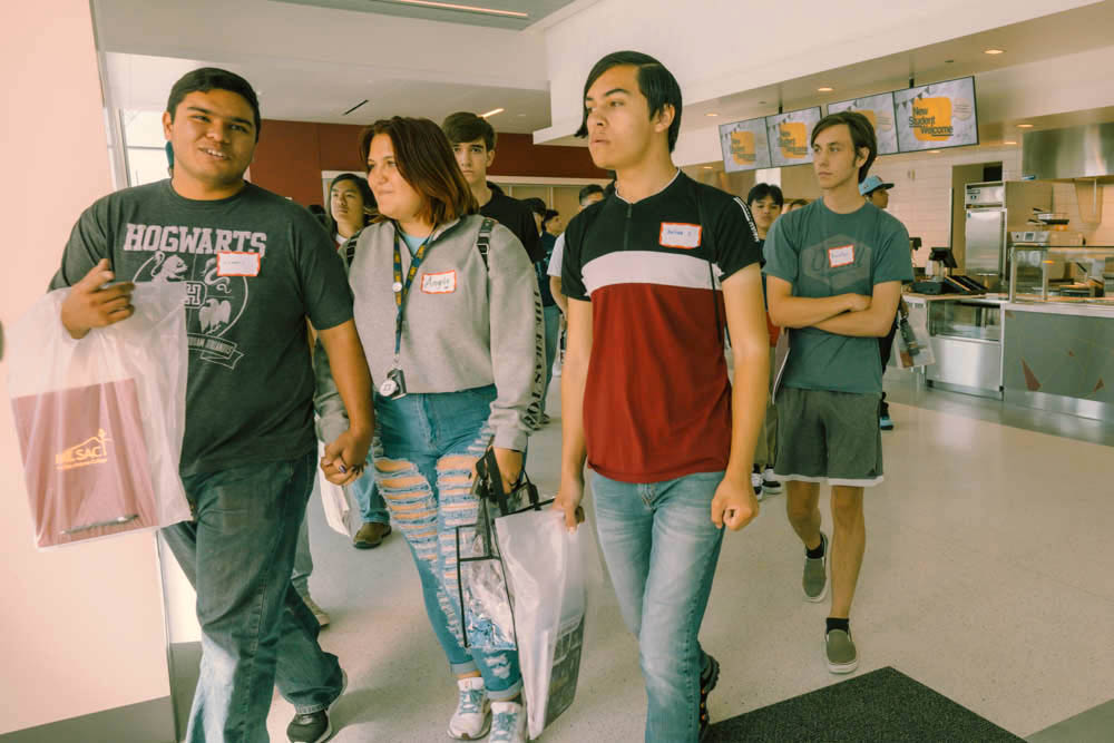 Students walk out of Center at the cafe.