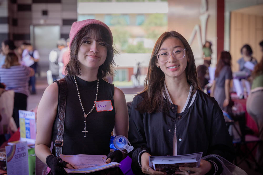 Two students smile