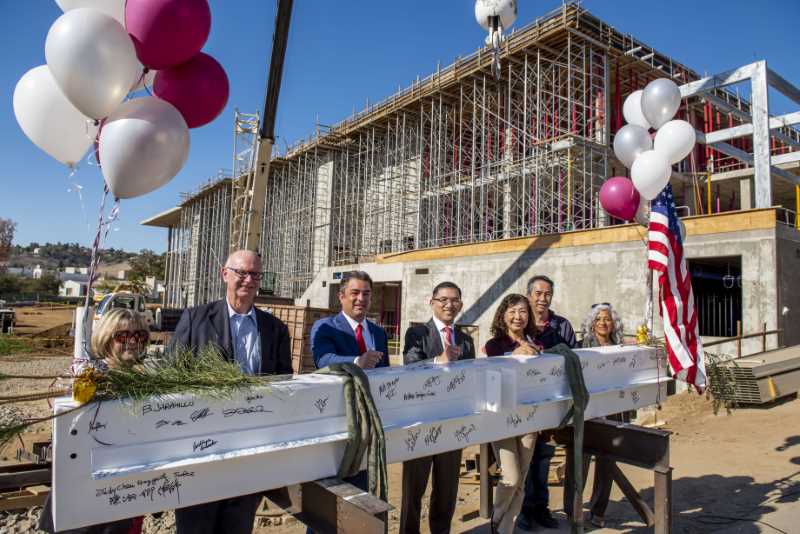 Campus leaders sign final beam