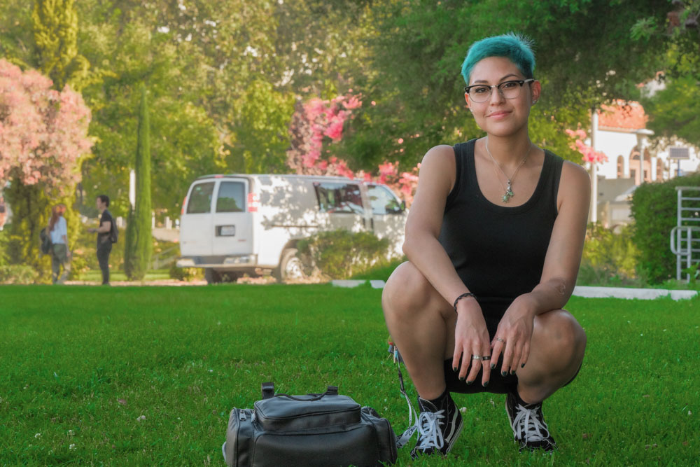 Stephanie Zepeda crouches in the shade of a lawn