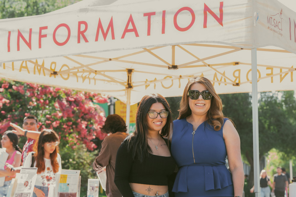 Dr. Garcia (R) with student at an information booth