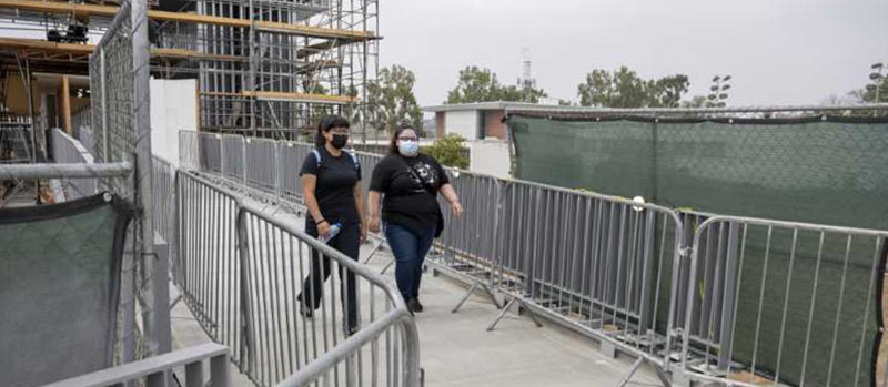 Students walk across Pedestrian Bridge