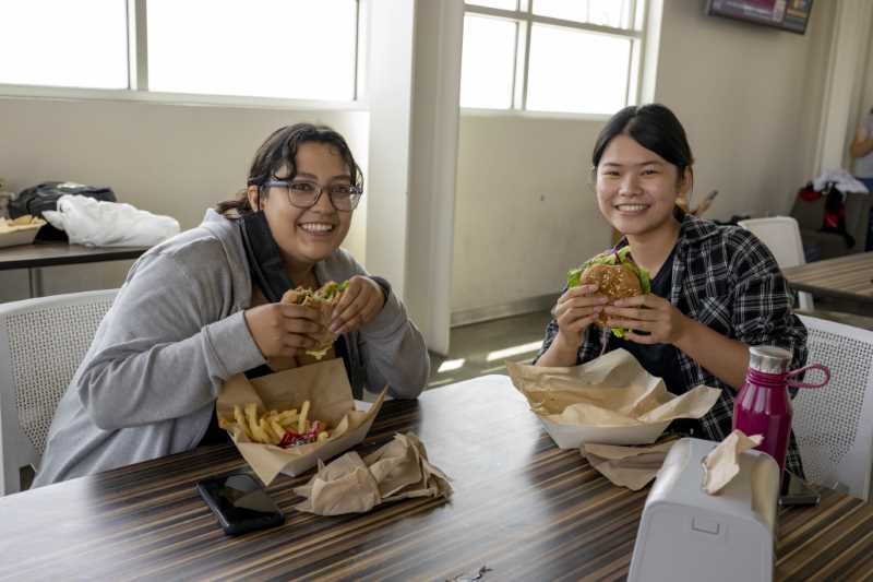 Students pose with their burgers at the Mountie Cafe