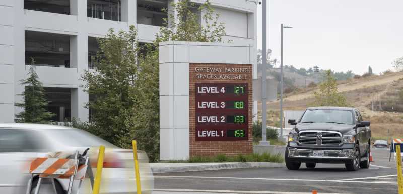 Trucks pulls out of Gateway Structure with sign showing hundreds of spaces available