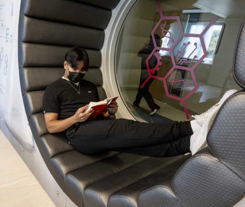 Student studies in unusual circular alcove at the STEM Center