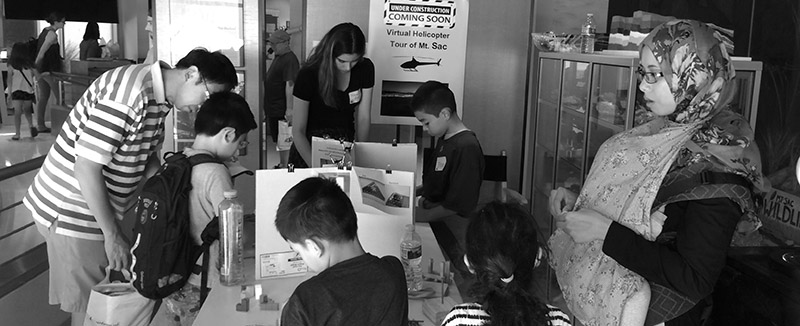 A family enjoys a science exhibit