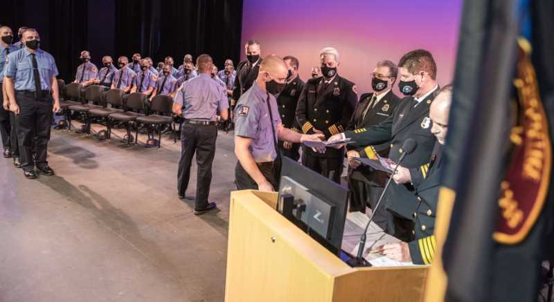 Grads are handed their certificate