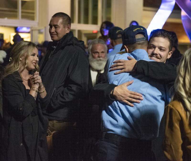 Family hugs a grad