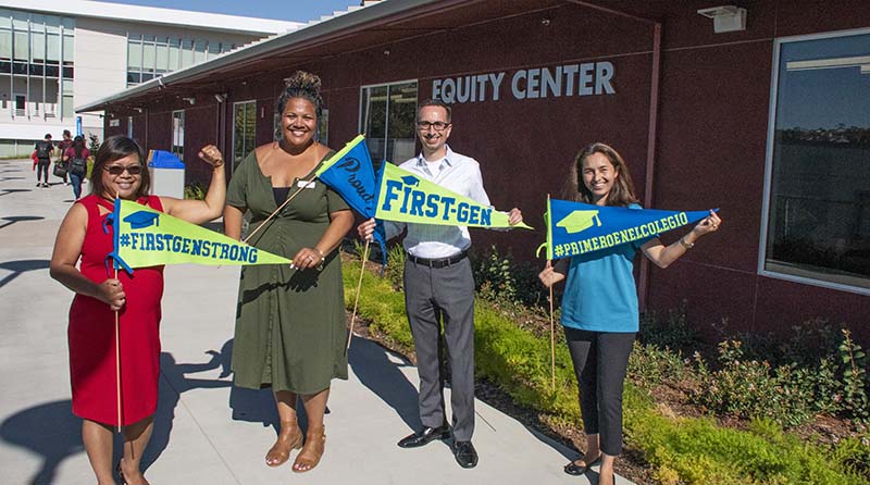 Equity Center staff holding First-Generation flags