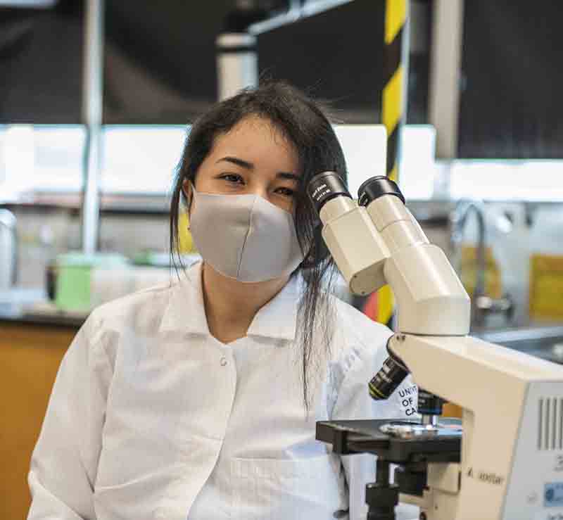 student at microscope