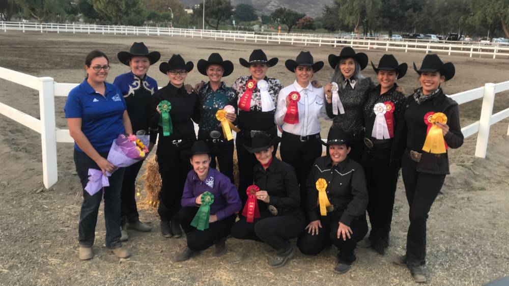 The horse show team with ribbons