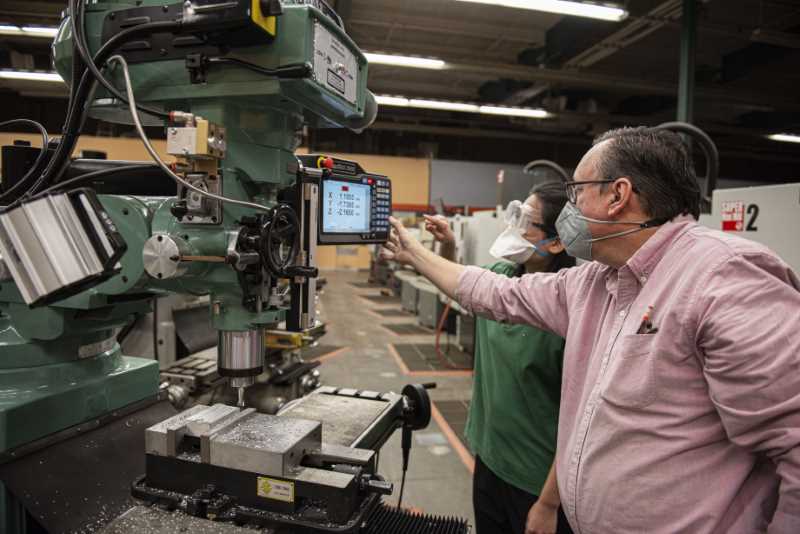 Stephen James instructs student on how to use donated Trak machine