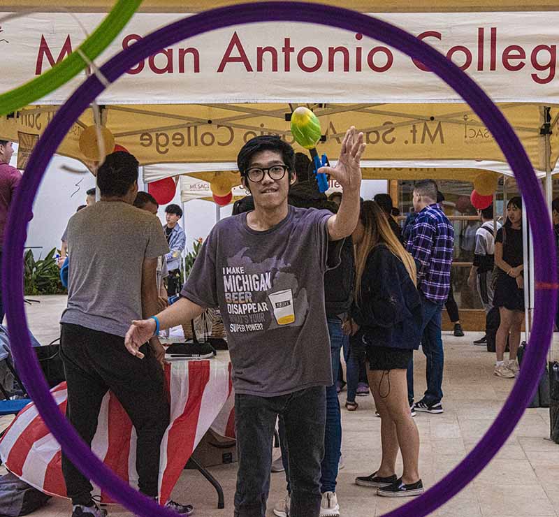 Student throws a mini football through a ring