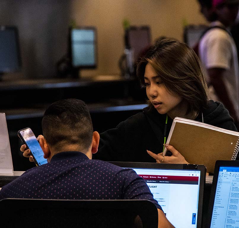 A student seeks assistance in the library