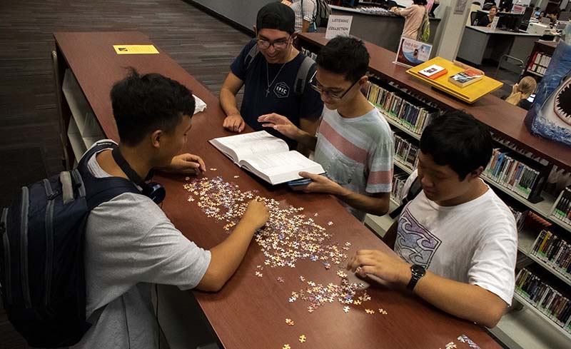 students work on a puzzle