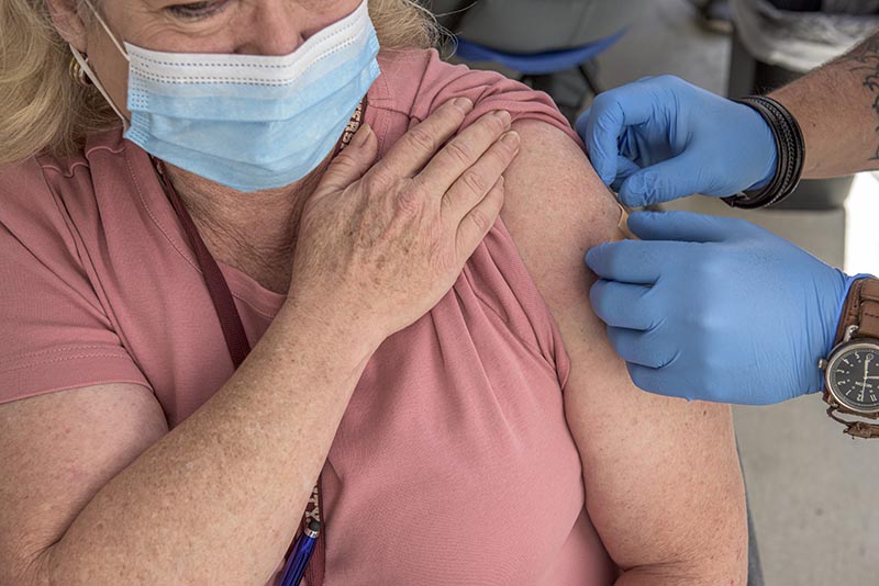 Woman is bandaged after getting vaccine